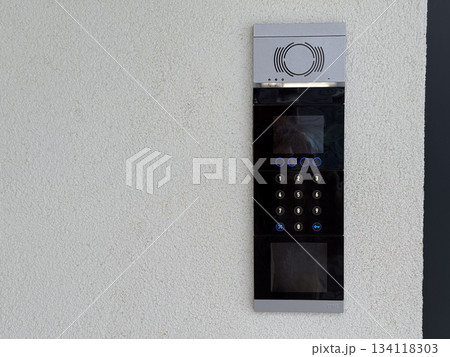 Entrance intercom with keypad. Security access, residential building control and modern communication technology. Copy space Entrance intercom with keypad. Security access, residential building control and modern communication technology. Copy space 134118303