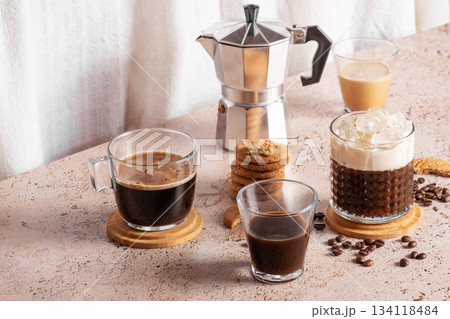 Freshly brewed espresso, iced coffee and moka pot in cozy kitchen setup 134118484