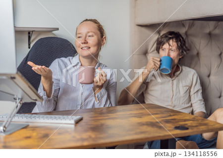 Man and woman working together in their home office, discussing tasks and collaborating on a project. Modern remote work, teamwork and productivity concept, representing communication, focus and Man and woman working together in their home office, discussing tasks and collaborating on a project. Modern remote work, teamwork and productivity concept, representing communication, focus and 134118556