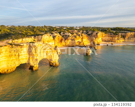 Marinha Beach, Cliffs and Atlantic Ocean on Sunny Morning. Aerial View. Portugal 134119392