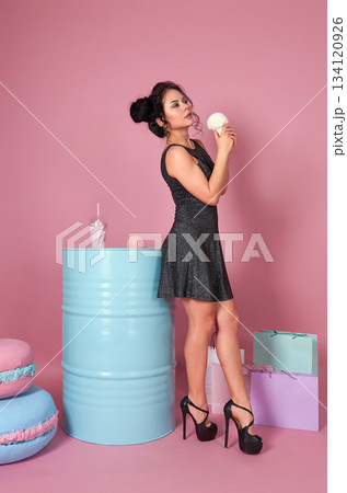 Stylish Woman with Faux Ice Cream in Pastel Studio Stylish Woman with Faux Ice Cream in Pastel Studio 134120926