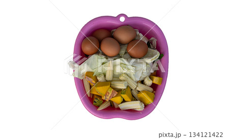Above of many Ingredients for cooking in the pink pan plastic. Inside with Eggs Cabbage Baby corn and Pumpkin. On isolated white background. Above of many Ingredients for cooking in the pink pan plastic. Inside with Eggs Cabbage Baby corn and Pumpkin. On isolated white background. 134121422