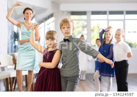 Children dance in pairs at festive matinee Children dance in pairs at festive matinee 134124597
