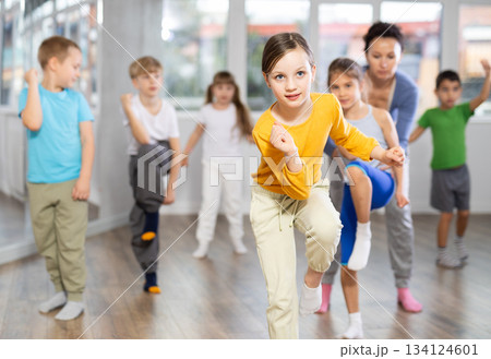 Children learn to dance modern dances under guidance of experienced teacher 134124601