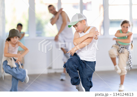 Preteen boy doing hip hop dance during group class Preteen boy doing hip hop dance during group class 134124613