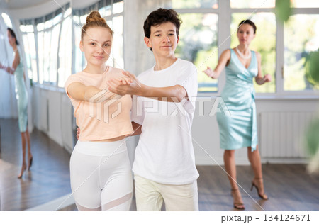 Girl and a boy are having fun learning to dance tango at choreographic school 134124671