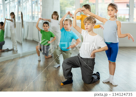Happy preteen children practicing ballroom dances in pairs in training hall 134124735