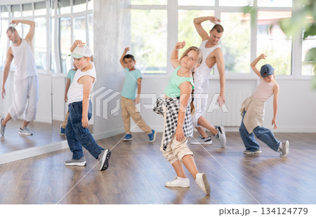 Preteen girl performing hip hop during group dance class Preteen girl performing hip hop during group dance class 134124779