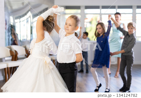 Children dance in pairs at festive matinee Children dance in pairs at festive matinee 134124782