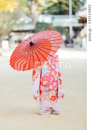 和傘をさして七五三のお参りをする女の子 134124802