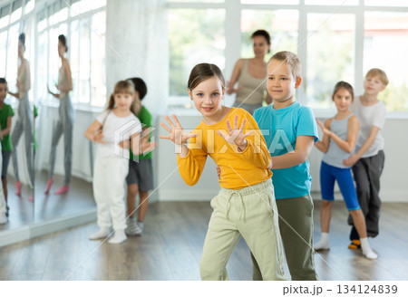 Positive juvenile boy and girl engaged in Rock 'n' Roll dance during dancing classes 134124839