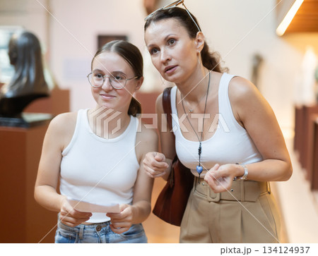 Woman and teenage girl looking at sculpture hall 134124937