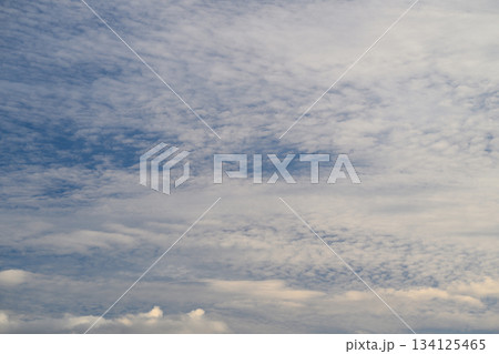 A clear afternoon with a beautiful blue sky and soft, fluffy clouds floating above A clear afternoon with a beautiful blue sky and soft, fluffy clouds floating above 134125465