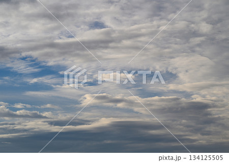 A stunning dynamic cloudscape featuring beautiful highlights set against a bright blue sky 134125505