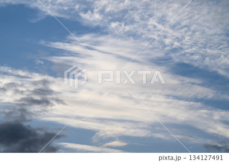The Serene and Tranquil Skies with Beautiful Wispy Clouds Stretching Across the Horizon 134127491