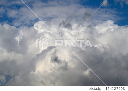 A Dramatic and Striking Cloud Formation Alongside a Bright Blue Sky Positioned Over Us A Dramatic and Striking Cloud Formation Alongside a Bright Blue Sky Positioned Over Us 134127498