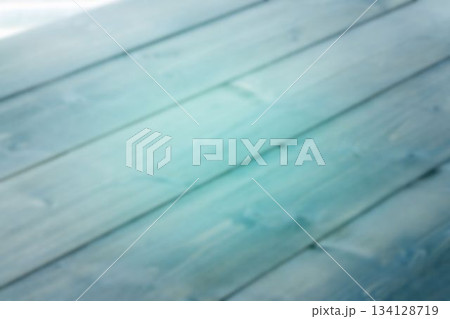 Flat design is showing blurred wooden deck planks lying diagonally in turquoise gradient tones Flat design is showing blurred wooden deck planks lying diagonally in turquoise gradient tones 134128719