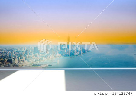 Flat design showing waterfront city skyline through clear glass barrier with white ledge shadow Flat design showing waterfront city skyline through clear glass barrier with white ledge shadow 134128747