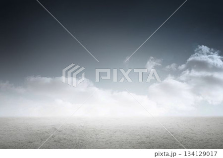 Image of white clouds lit by sunlight over horizon, sea and empty beach Image of white clouds lit by sunlight over horizon, sea and empty beach 134129017