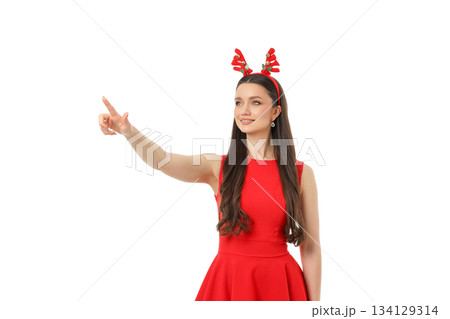 Woman in red dress with reindeer headband points, isolated, PNG 134129314
