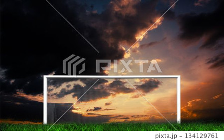 Football goal under sunset cloudy sky 134129761