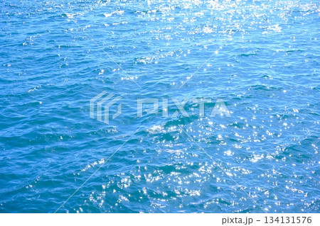 太陽の光がきらめく、鮮やかな青い海面 134131576