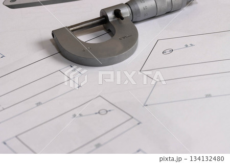 Precision micrometer placed on engineering technical drawings Precision micrometer placed on engineering technical drawings 134132480