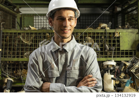Technician worker working and smile to the camera in garage scrap yard car workshop warehouse. Technician worker working and smile to the camera in garage scrap yard car workshop warehouse. 134132919