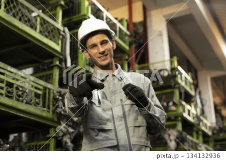 Technician worker working and smile to the camera in garage scrap yard car workshop warehouse. Technician worker working and smile to the camera in garage scrap yard car workshop warehouse. 134132936