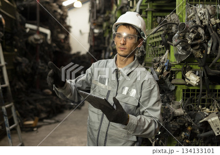 Technician worker working and checking in garage scrap yard car workshop warehouse. Technician worker working and checking in garage scrap yard car workshop warehouse. 134133101