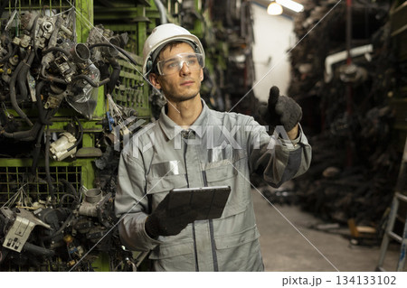 Technician worker working and checking in garage scrap yard car workshop warehouse. Technician worker working and checking in garage scrap yard car workshop warehouse. 134133102