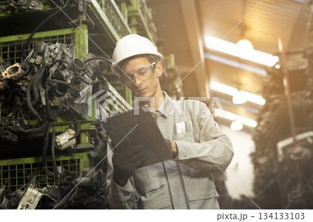 Technician worker working and checking in garage scrap yard car workshop warehouse. Technician worker working and checking in garage scrap yard car workshop warehouse. 134133103
