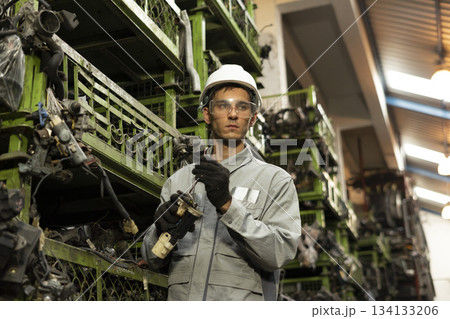 Technician worker working and checking in garage scrap yard car workshop warehouse. 134133206