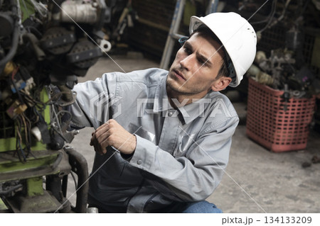 Technician worker working and checking in garage scrap yard car workshop warehouse. Technician worker working and checking in garage scrap yard car workshop warehouse. 134133209