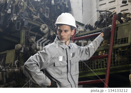 Technician worker working and checking in garage scrap yard car workshop warehouse. Technician worker working and checking in garage scrap yard car workshop warehouse. 134133212