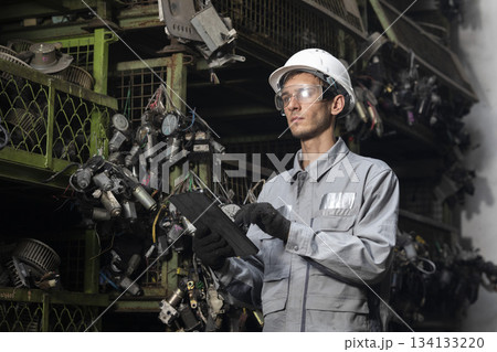 Technician worker working and checking in garage scrap yard car workshop warehouse. Technician worker working and checking in garage scrap yard car workshop warehouse. 134133220