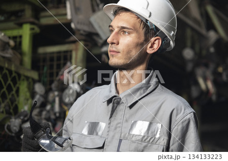 Technician worker working and checking in garage scrap yard car workshop warehouse. 134133223