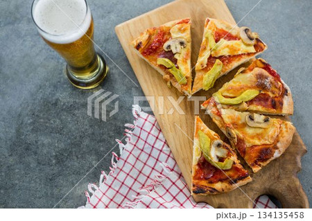 Pizza slices with beer glass on table Pizza slices with beer glass on table 134135458