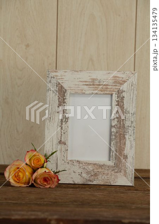 Photo frame and flowers on table Photo frame and flowers on table 134135479