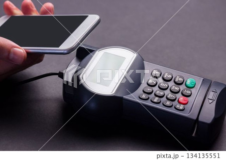 Man using smartphone to express pay Man using smartphone to express pay 134135551