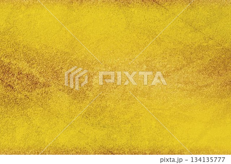 Golden grainy texture is creating uniform surface in flat design abstract background, copy space 134135777