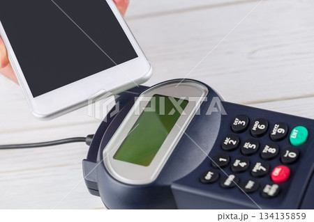 Man using smartphone to express pay Man using smartphone to express pay 134135859