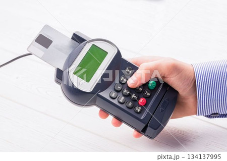 Man paying with credit card Man paying with credit card 134137995