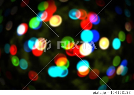 Cluster of defocused colored light circles is floating in bokeh effect over dark backdrop Cluster of defocused colored light circles is floating in bokeh effect over dark backdrop 134138158