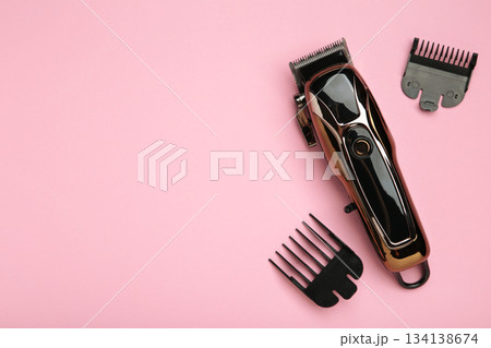 Hair clipper on pink background. Modern hair clipper. Hair clipper on pink background. Modern hair clipper. 134138674