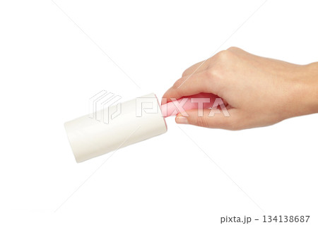 Woman holding lint roller isolated on white background. Top view Woman holding lint roller isolated on white background. Top view 134138687