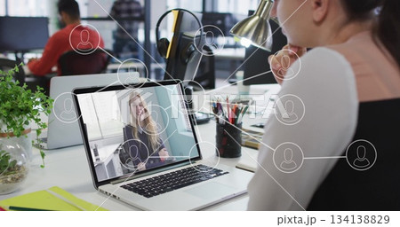 Joining remote call via laptop interface, woman wearing formal attire at desk in office, copy space Joining remote call via laptop interface, woman wearing formal attire at desk in office, copy space 134138829