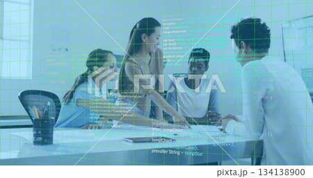 Collaborating team pointing at code on laptop in corporate meeting room, with notebooks and mug 134138900
