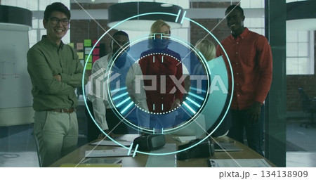 Standing professionals in business attire reviewing documents in meeting room, with VR headset 134138909