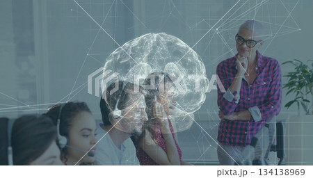 Projecting holographic brain network hovering above call center agents at office, with headsets 134138969